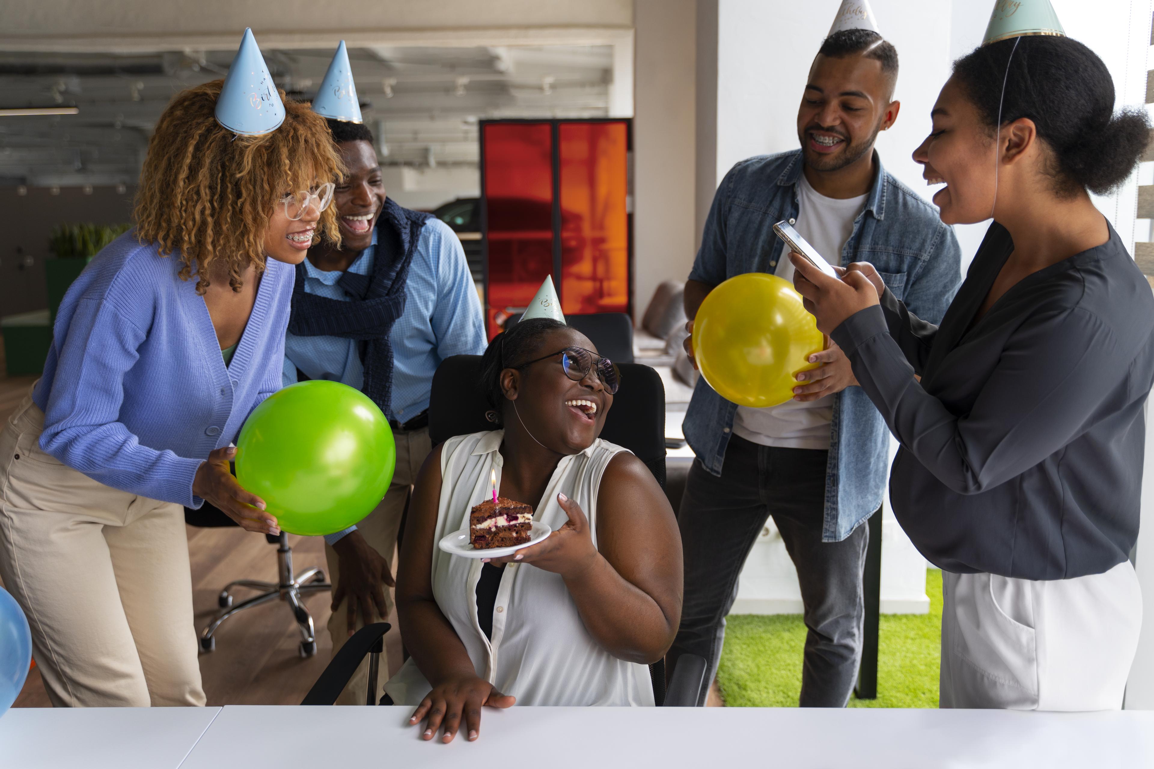 Simpler team members celebrating a colleague's life milestone together